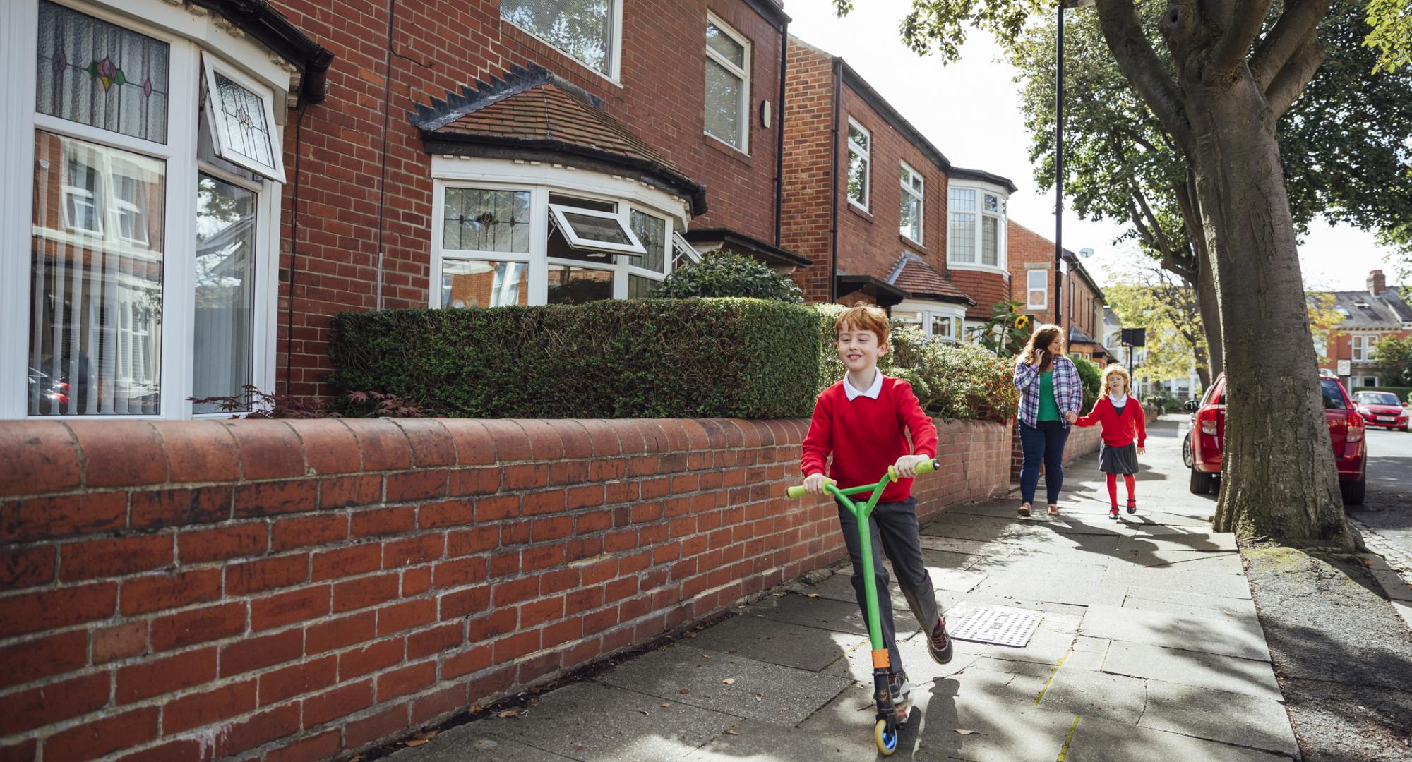 Manchester child using a scooter to get to school