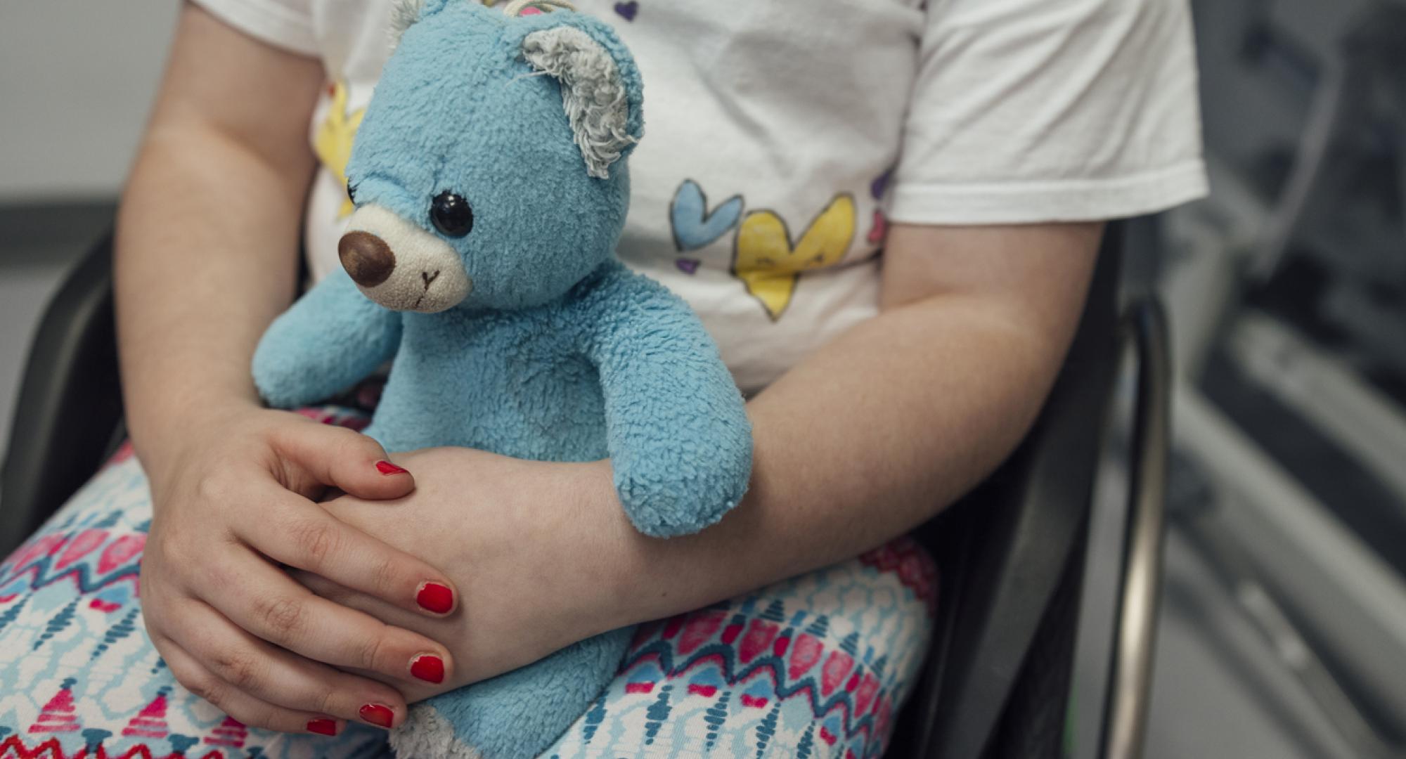 Small child holding a teddy