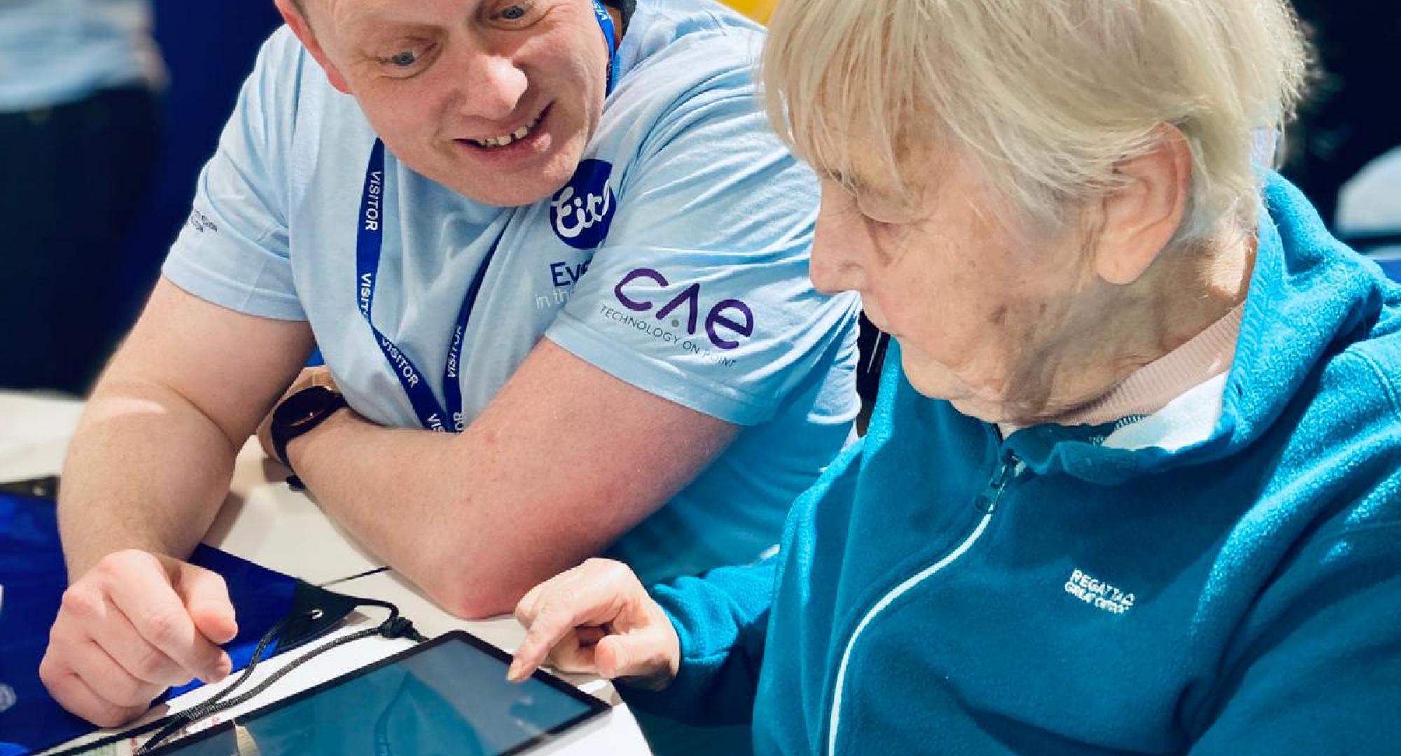 Old person being helped with IT