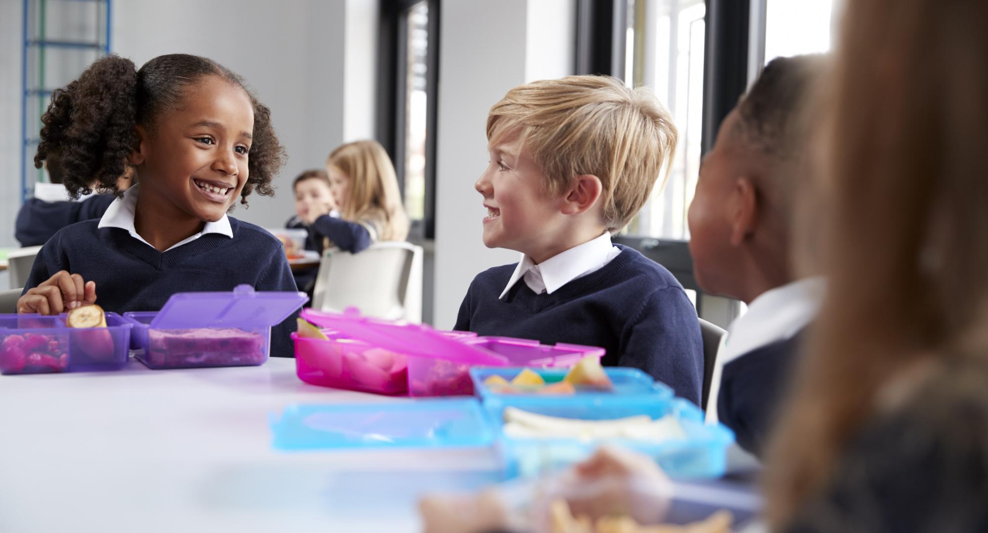 Primary school children eating breakfast