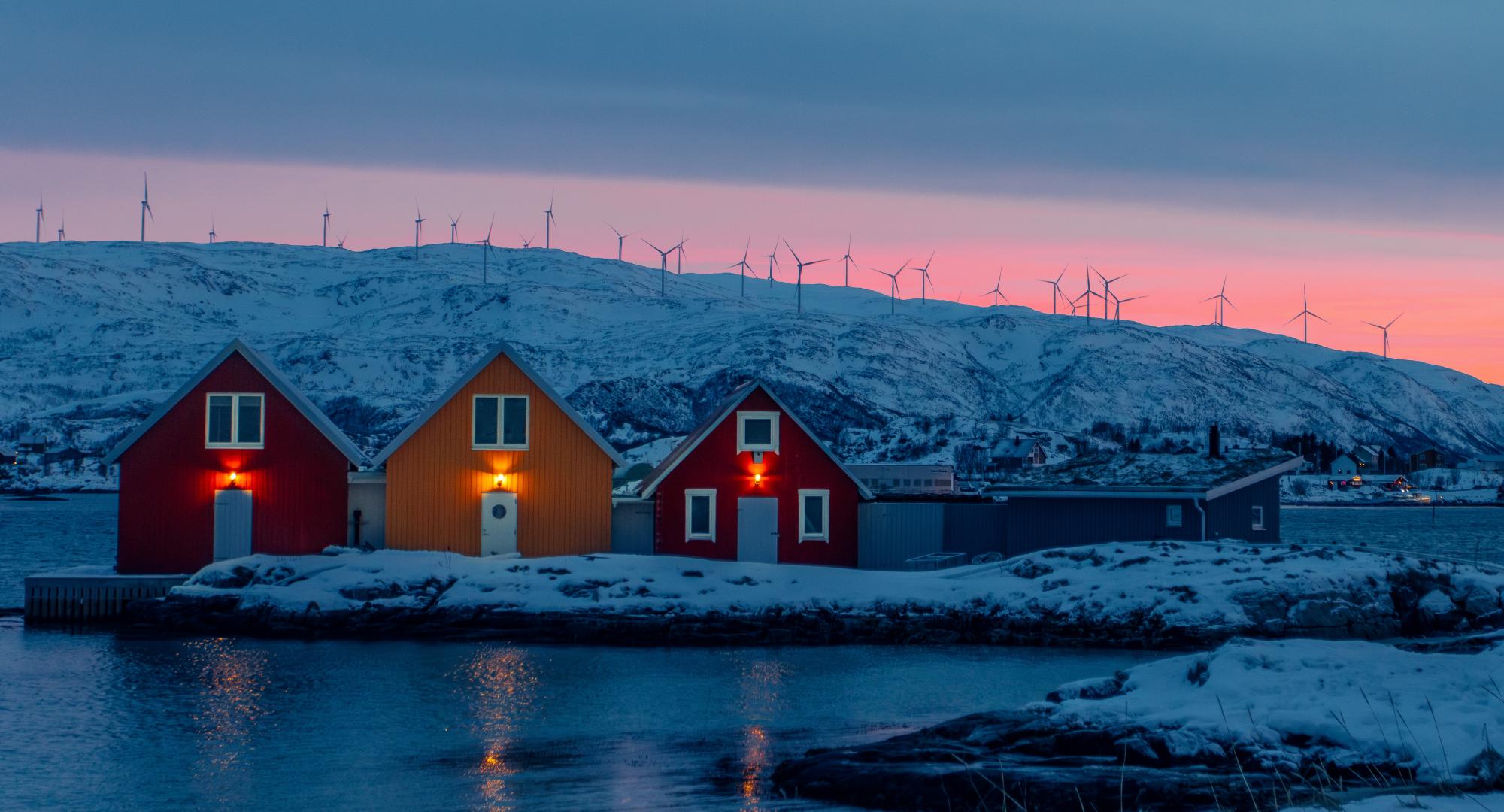 House in Norway with wind turbines behind
