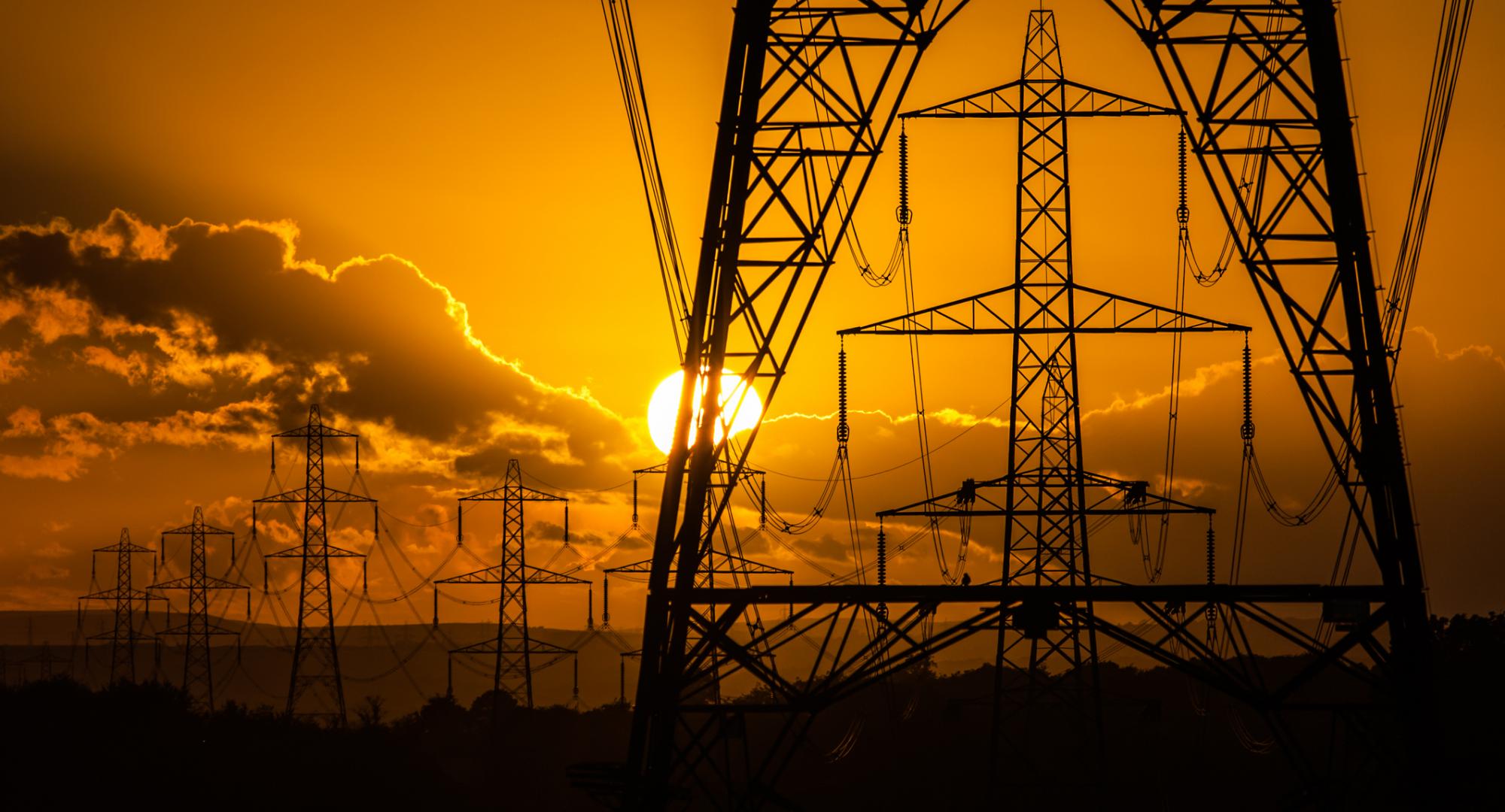 Sunset and silhouette of electricity pylons