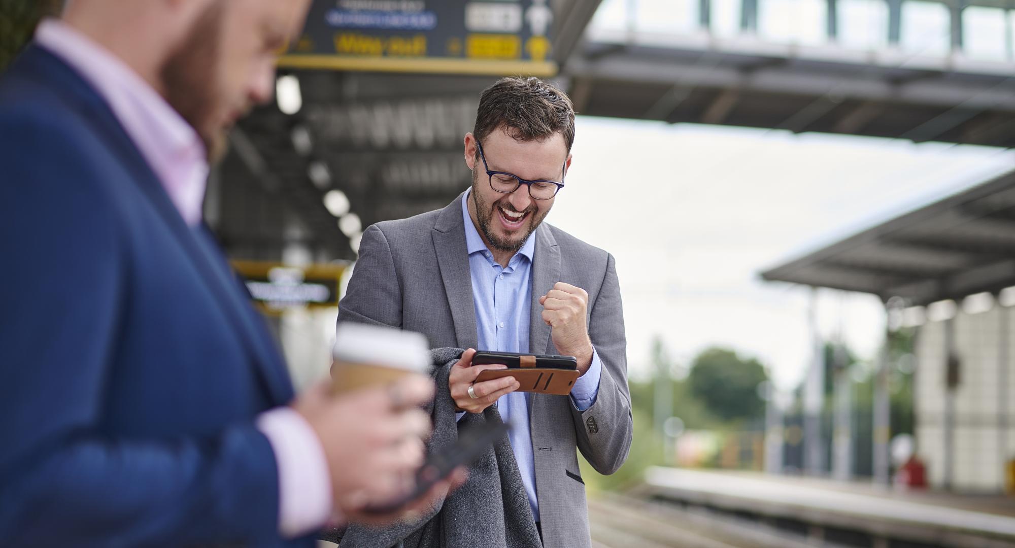 Men on phone at railway station