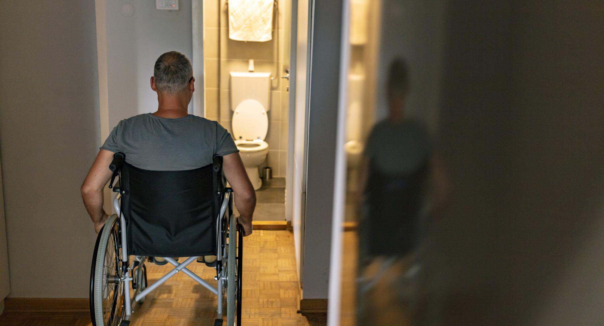 Rear view of mature man on wheelchair