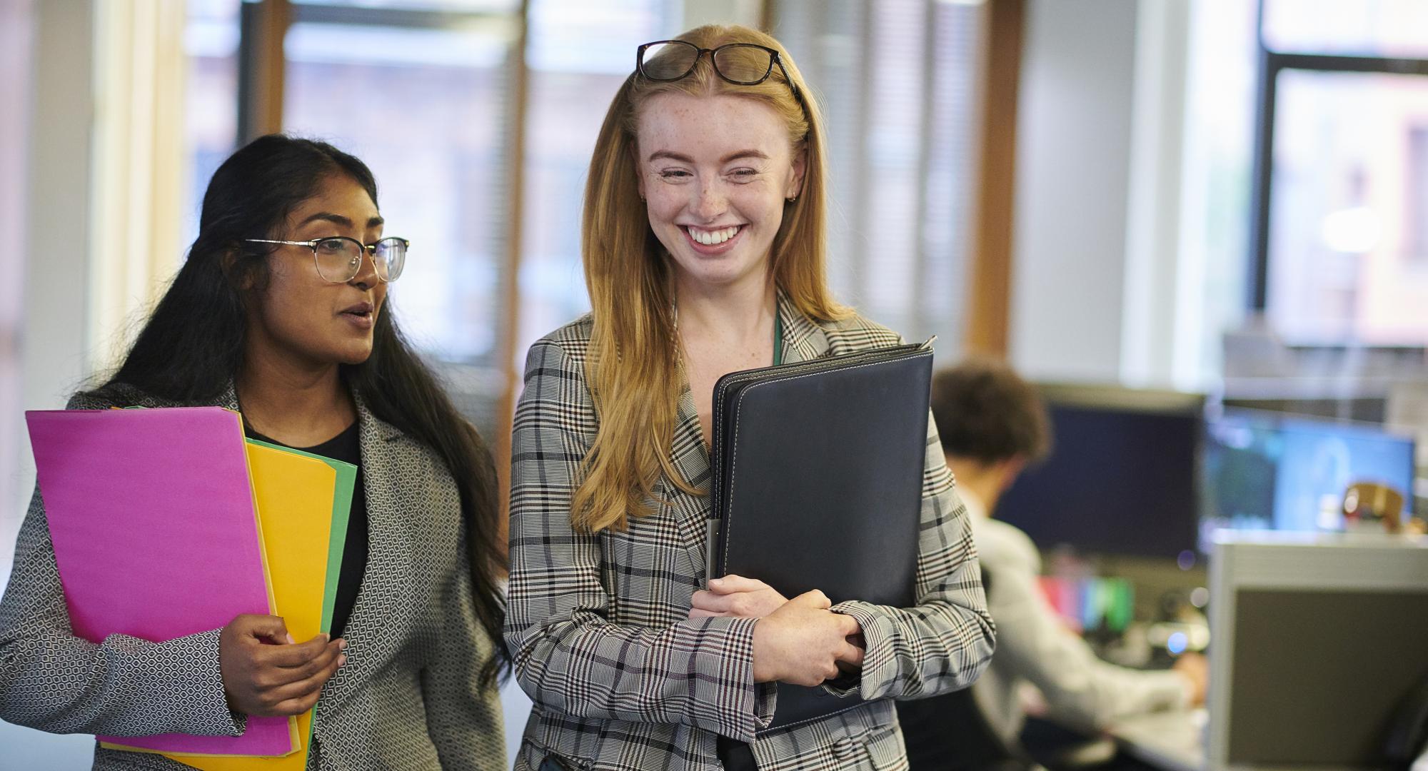 Two interns walking through an office