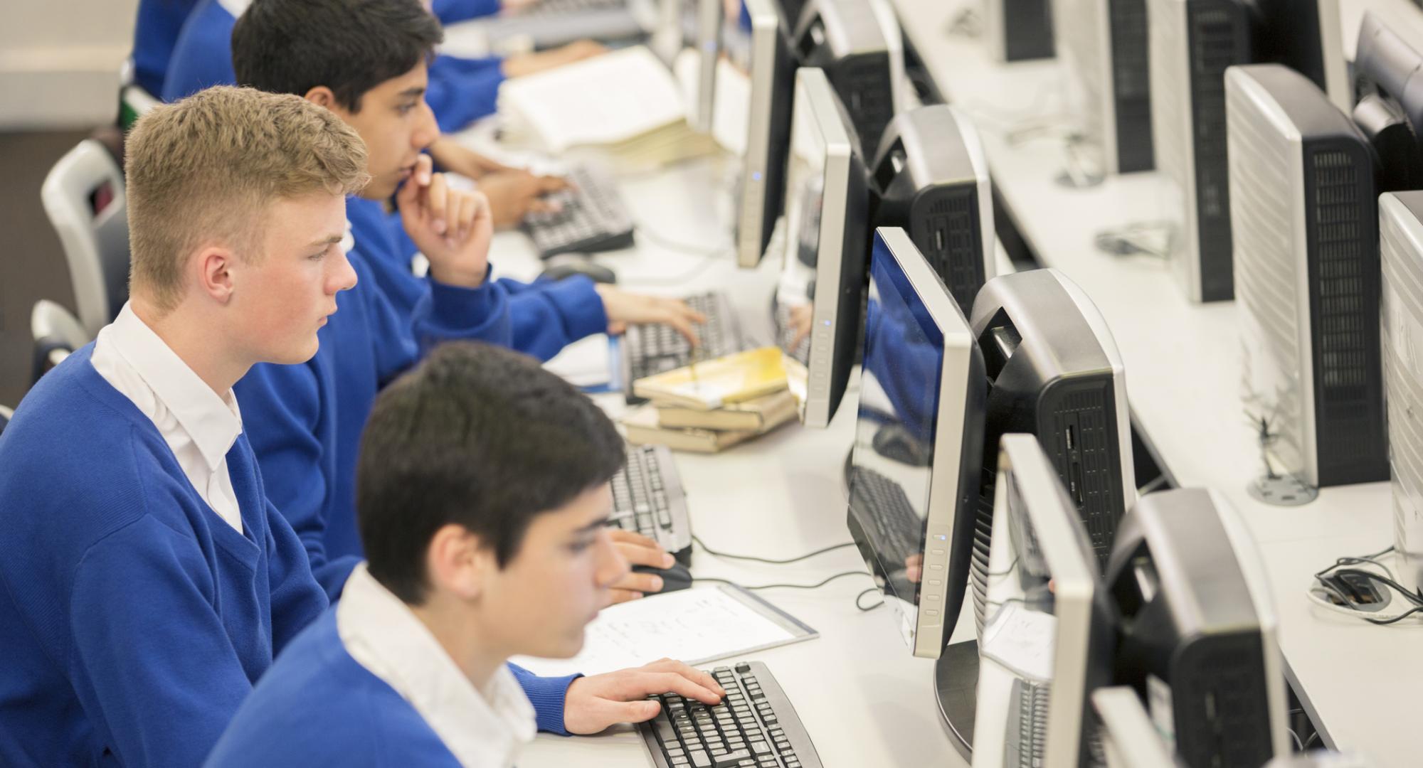 Teenage students using computers