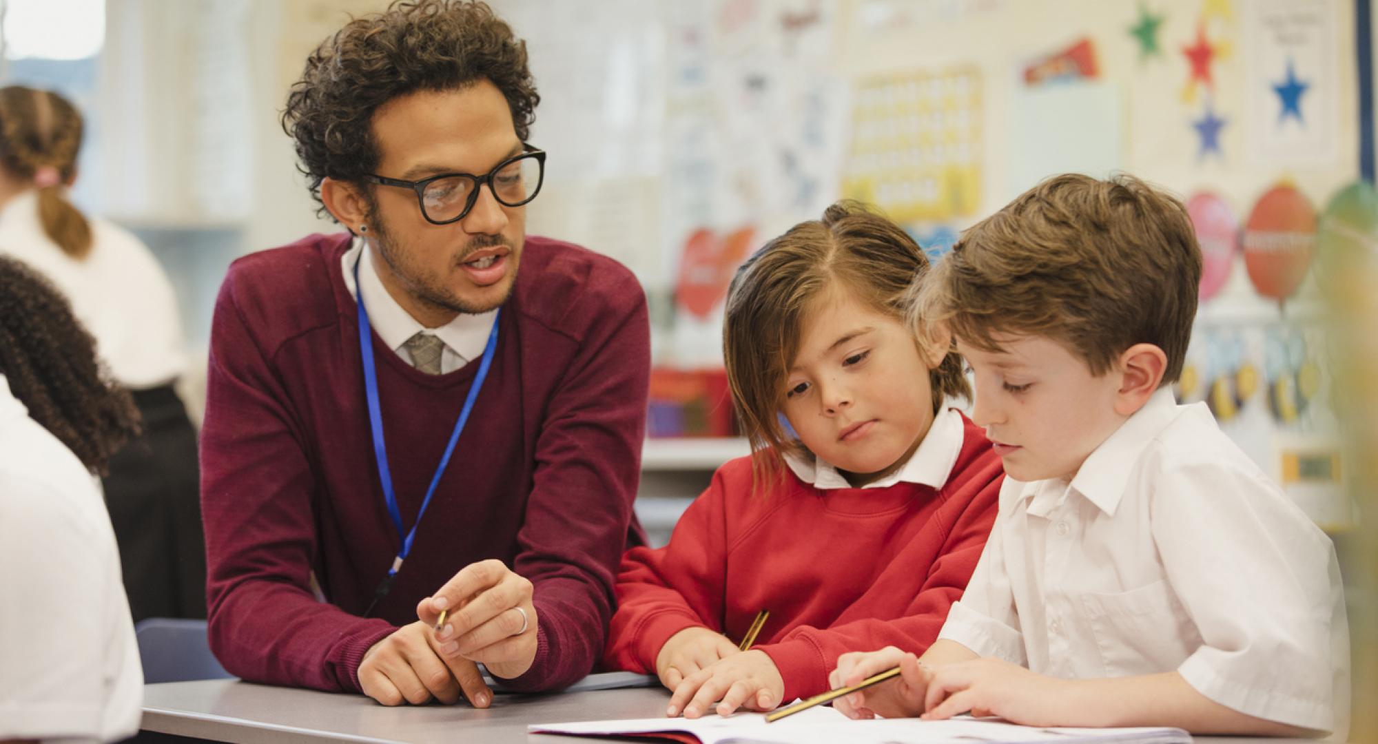 Teacher working with two students