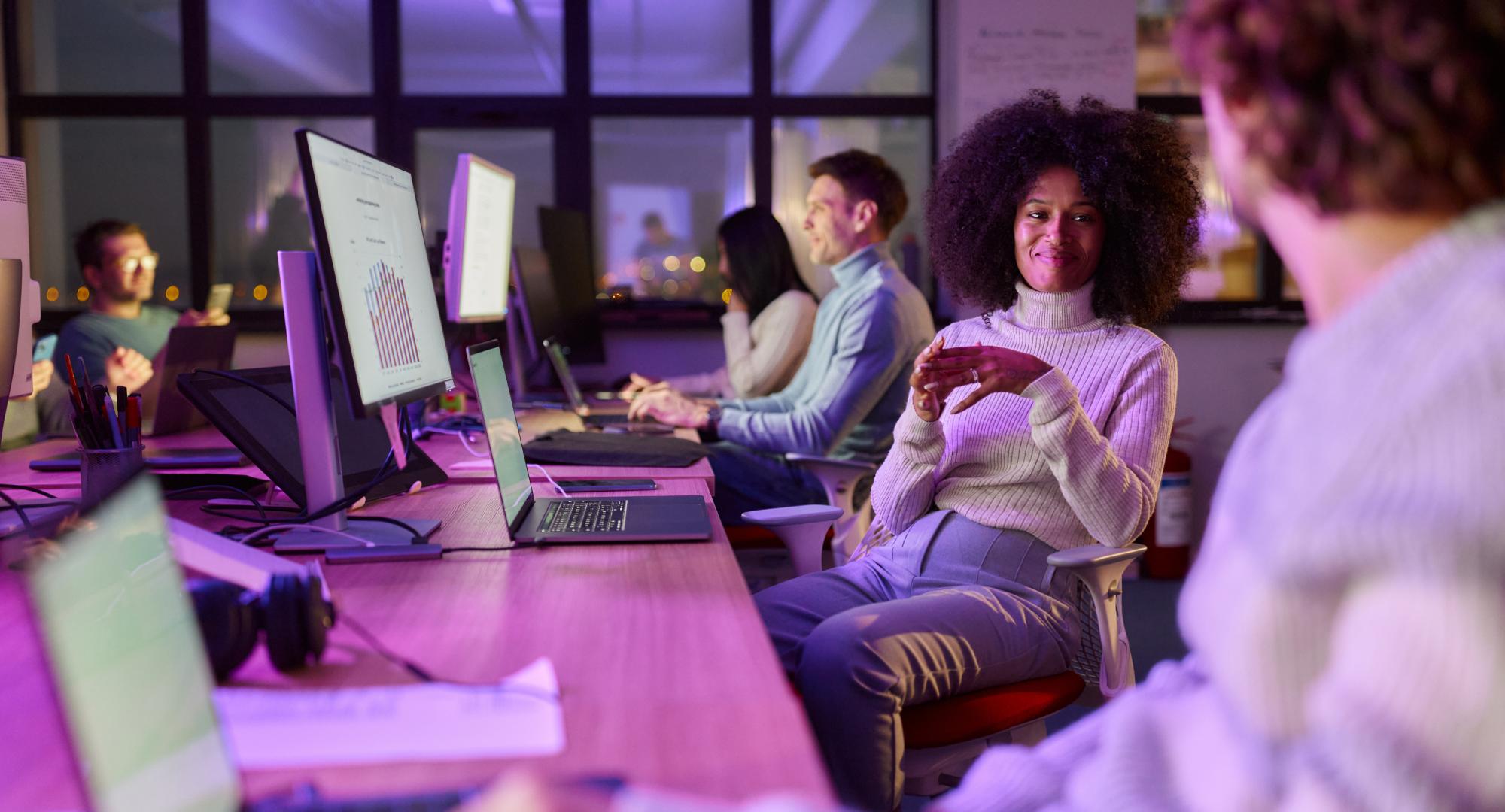 Creative woman talking with colleagues