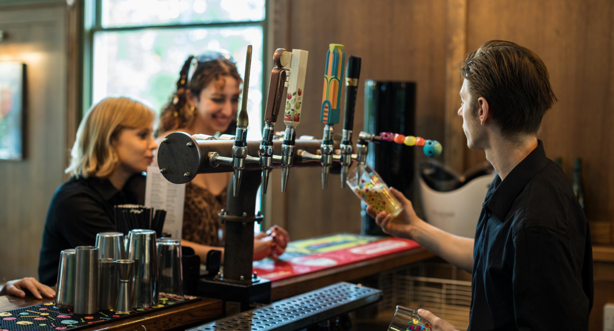 Young man working behind a bar