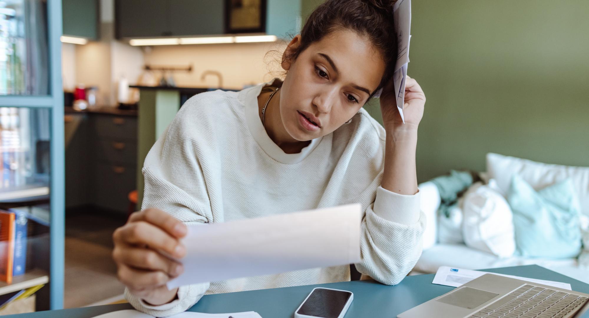 Woman looking at household bills