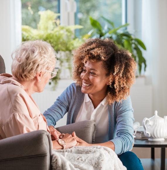 Social care worker helps elderly woman