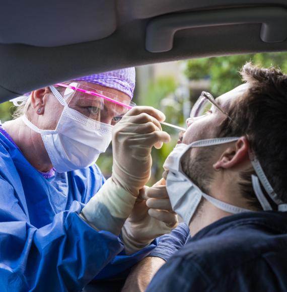 Man getting tested for Covid-19 in his car.