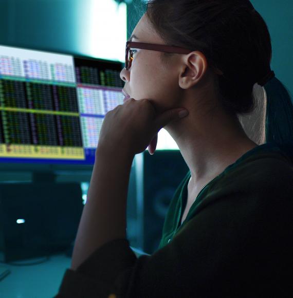 Woman sat at a computer analysing data