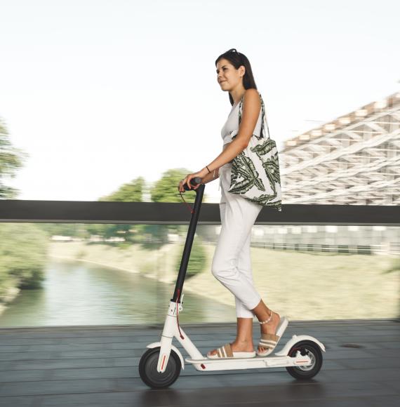 Woman rides an e-scooter