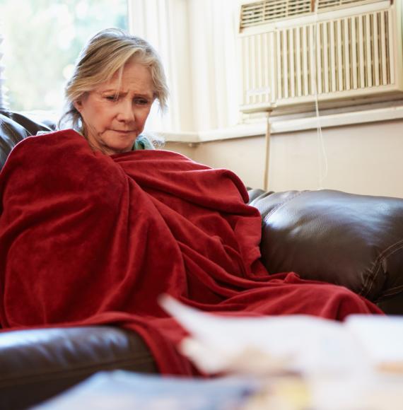 Woman is cold on couch.