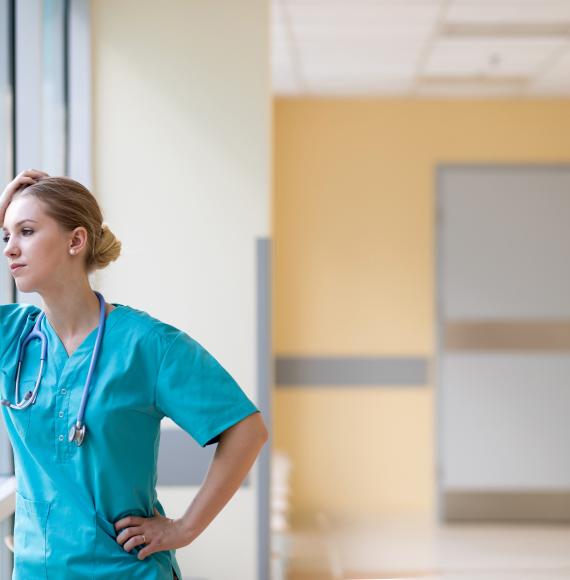 Nurse looking stressed at work