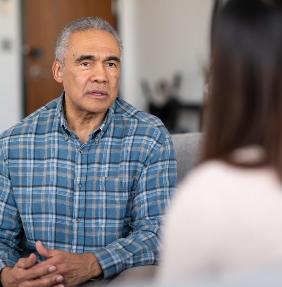 Man is spoken to by a woman to discuss his issues.