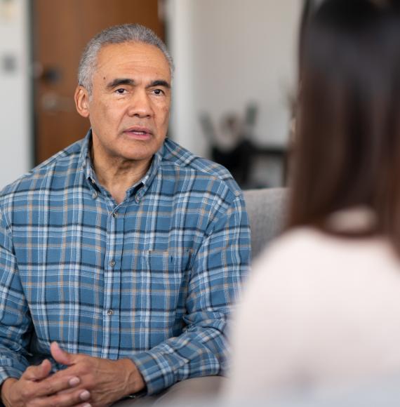 Man is spoken to by a woman to discuss his issues.