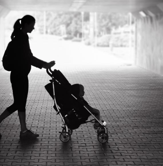 Black and white picture of single mum with pram.