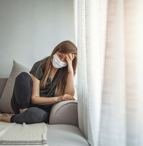 Girl isolates at home, looks sad