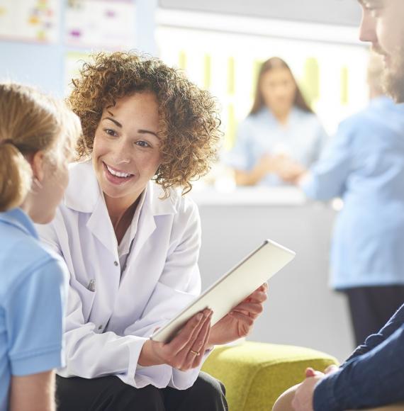 Female health professional talking with a young girl