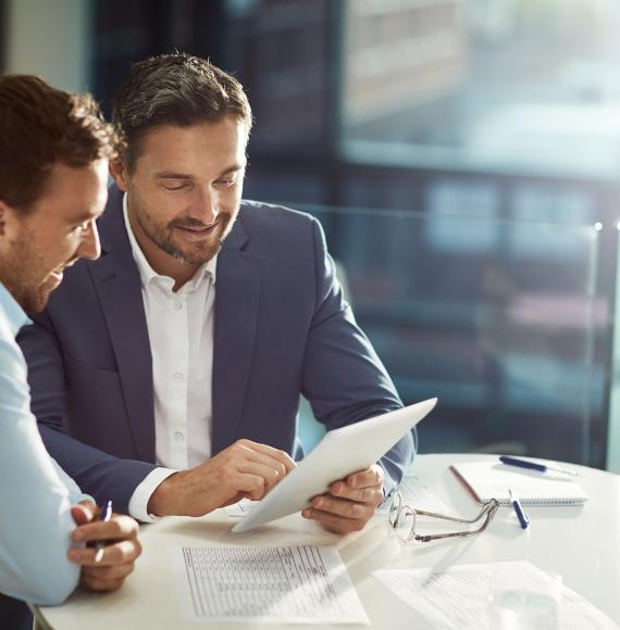 Two businessmen in discussions over a document