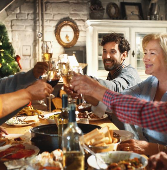 Family gathered around a dinner table at Christmas