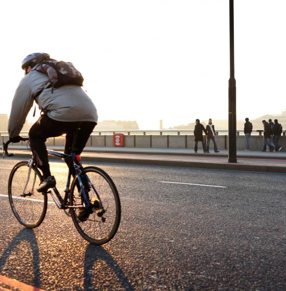 Man commutes to work on bicycle.