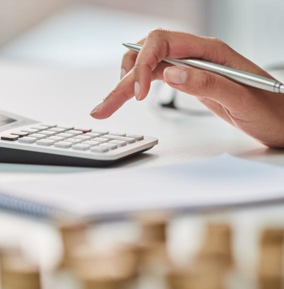 Woman uses calculator to work out her finances