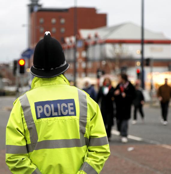 Police man stands guard in the street. 