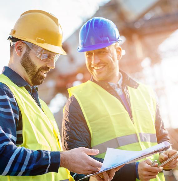 Construction workers discussing on a building site