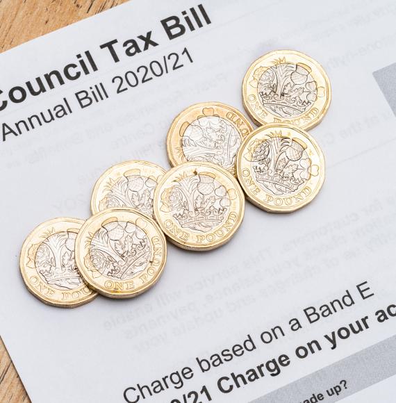 Council tax bill with coins on top.