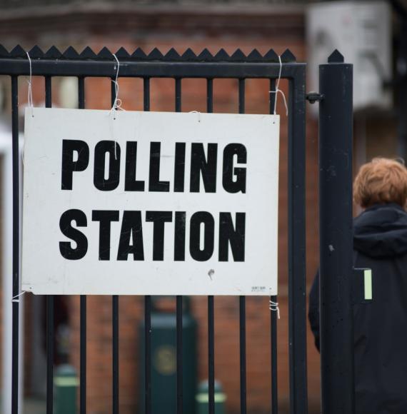 Man walks in to polling station. 