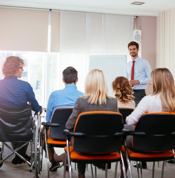 Man addresses a group of conference delegates