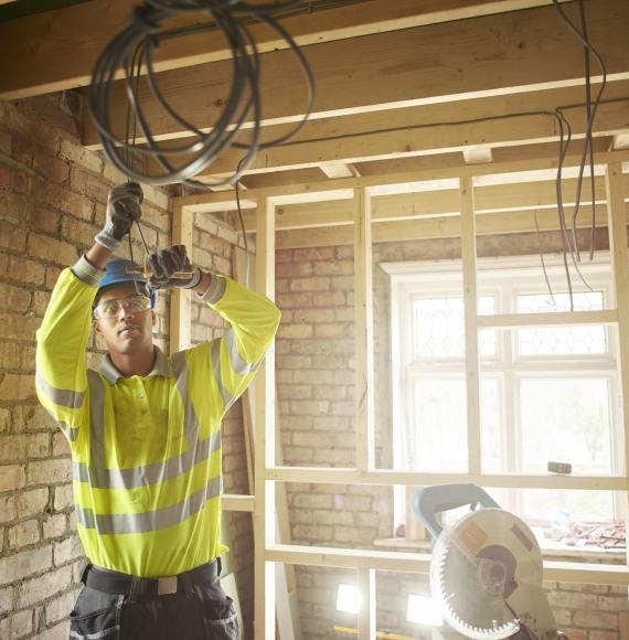 Electrician wiring up a newly built house