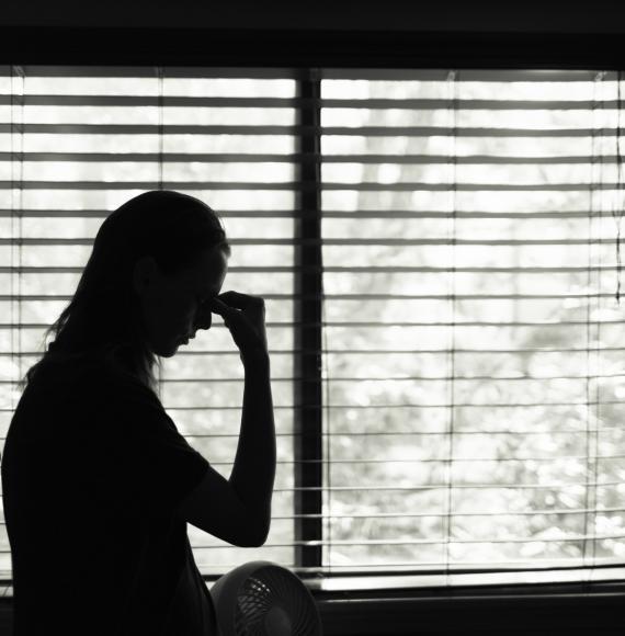 Woman sitting in bedroom