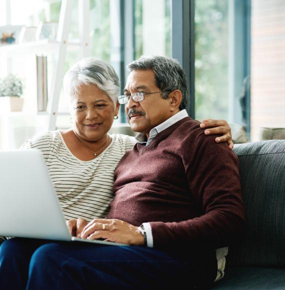 Elderly couple on laptop at home