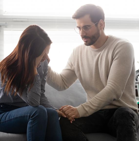 Man consoling woman