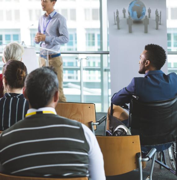 Man in wheelchair at business meeting