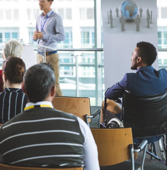 Man in wheelchair at business meeting