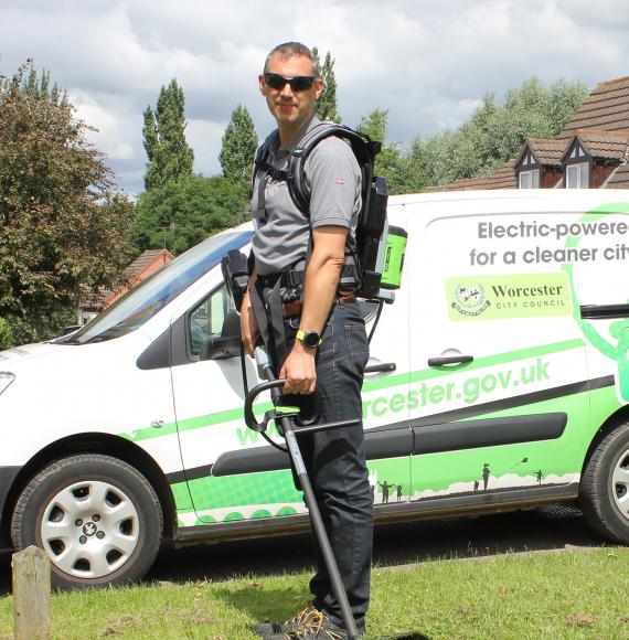 Councillor Andy Stafford with the electric grass strimmer