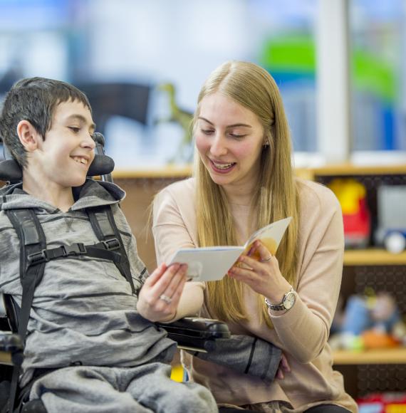 Learning disabilities worker helping a child