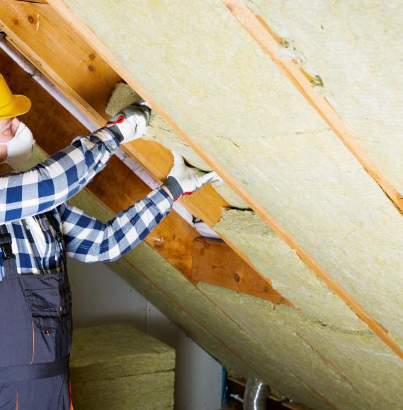 Man installing roof insulation