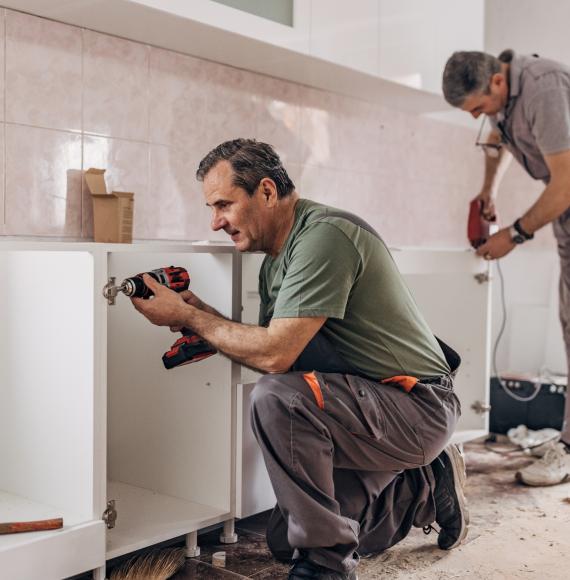 Kitchen being fitted in a council house