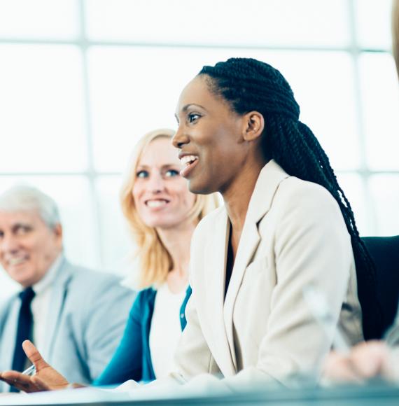 Woman on a panel talking at a meeting