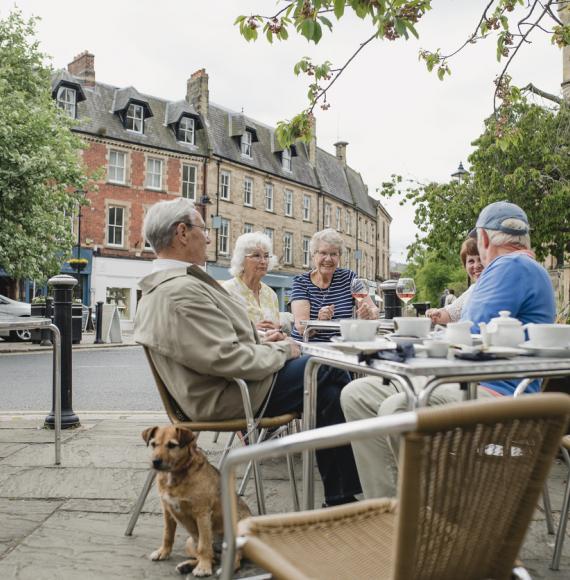 People sit outside a cafe in Hexham town centre