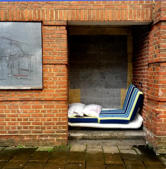 Mattresses stacked up in a doorway by a rough sleeper