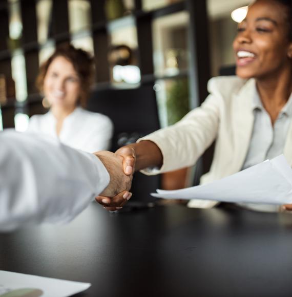 Young people shaking hands in an office