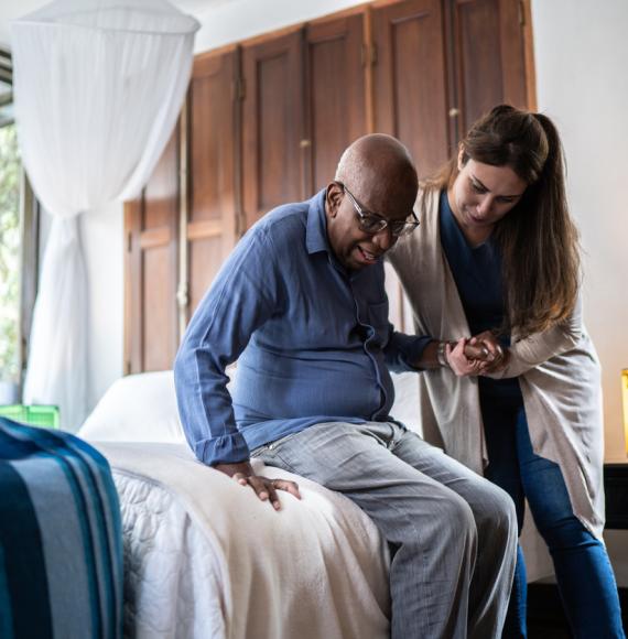 Woman giving care to an elderly man