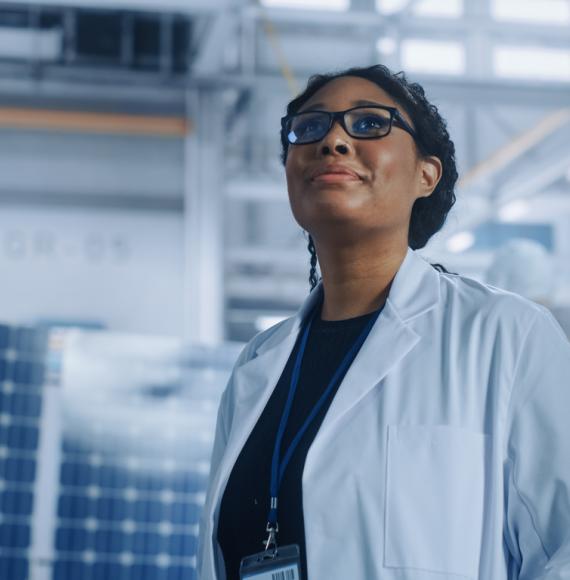 A female researcher is stood looking up